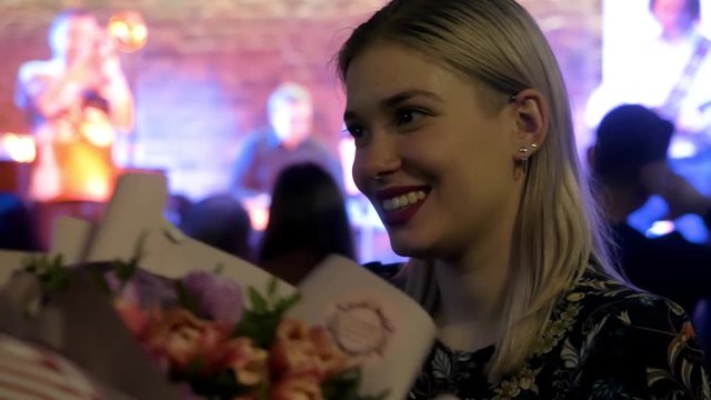 a beautiful girl in a nightclub learned amazing news. Girl shocked aying WOW
