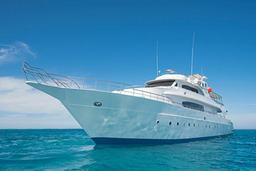 Fototapeta na wymiar Luxury motor yacht sailing out on tropcial sea