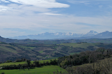Obraz premium landscape in the mountains,italy,spring,countryside,rural,panoramic,nature,view,field,hills,cloud,sky