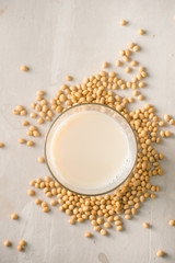 Soy milk or soya milk and soy beans on stone table.