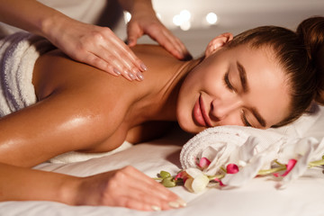 Fototapeta na wymiar Beautiful woman getting relax massage in spa center