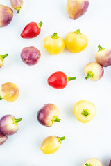 Fresh colorful peppers on white background