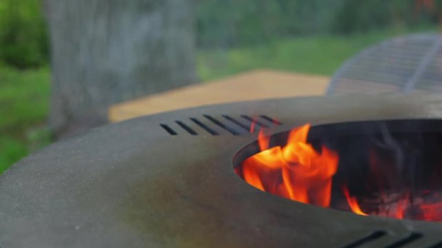 Preparing a new grill for use. Linseed oil on a white cloth. Use of oil for the first calcination of the frying surface. Female hand with a manicure. Happy people having camping and bbq party outdoor.