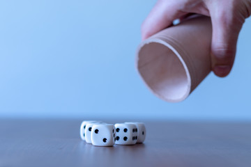 Hand of a man shaking leather yahtzee cup
