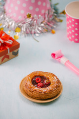 Fototapeta na wymiar Birthday party items with raspberry pie on table