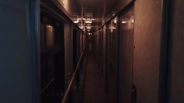 railroad travel concept coach train journey. view beautiful corridor in the compartment car from night moving train railway Russia winter. interior inside train lifestyle