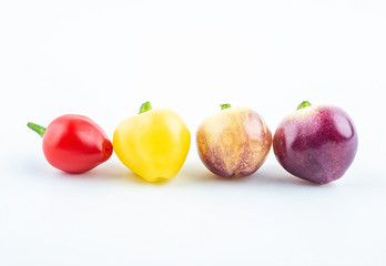 Fresh colorful peppers on white background