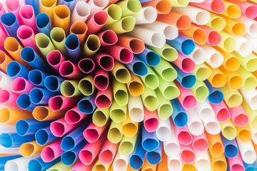 close up of colorful and bright plastic straws with copy space