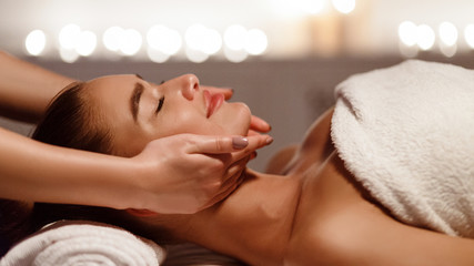 Obraz na płótnie Canvas Face massage. Young woman getting spa treatment