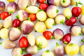 Fresh colorful peppers on white background