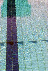 Fototapeta na wymiar Summer day at swimming pool. Background and texture concept. Ripple Water in swimming pool with sun reflection.