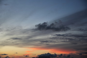 uninhabited island in the ocean against the red sunset