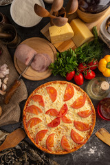 Beautiful pizza with ham and tomatoes