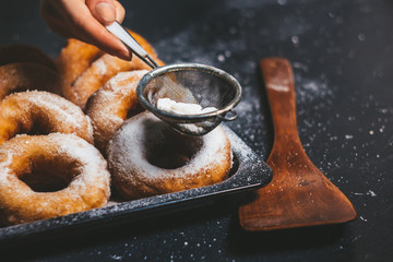 fresh donuts on a tray, sugar cakes from the oven, yeast donuts, baked goods