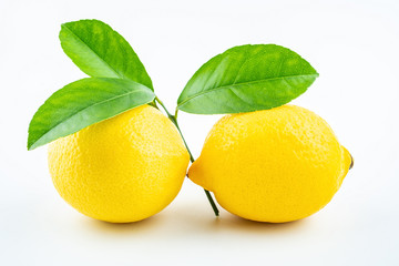 Fresh yellow lemon with leaves on white background