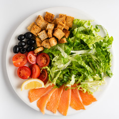 plate with red fish and vegetables