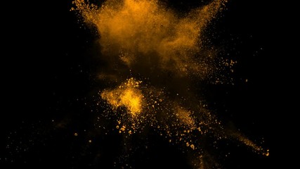 Super slowmotion shot of golden powder explosion isolated on black background.