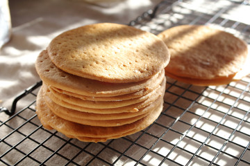 A stack of biscuits shortbread cookies pancake cakes for russian layered honey cake on cooling rack