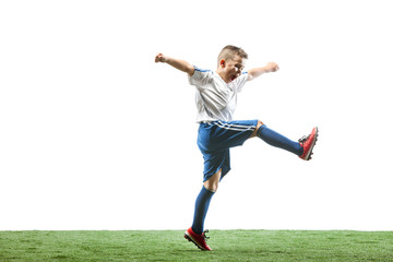 Fototapeta na wymiar Young boy running and jumping isolated on white studio background. Junior football soccer player in motion
