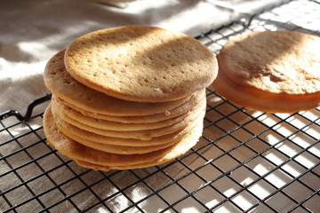 A stack of biscuits shortbread cookies pancake cakes for russian layered honey cake on cooling rack