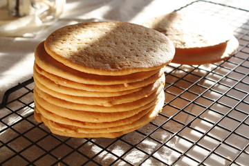 A stack of biscuits shortbread cookies pancake cakes for russian layered honey cake on cooling rack