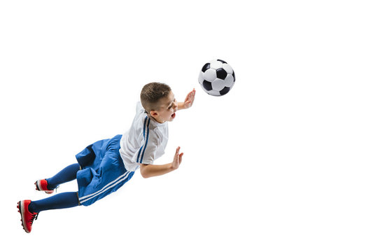 Young boy kicks the soccer ball. Isolated photo on white background. Football player in motion at studio. Fit jumping boy in action, jump, movement at game.