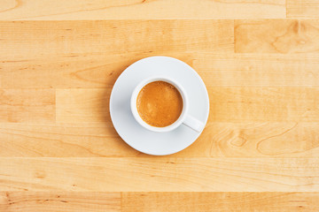 Cup of coffee or espresso on wooden table. Top view. Copy space for text. Flat lay.