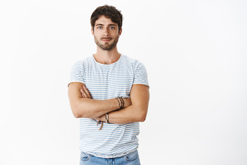 Portrait of good-looking confident and enthusiastic young masuline male fitness instructor holding...