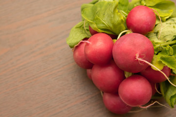 bunch of radishes on wooden table