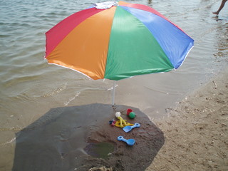 umbrella on the beach MULTICOLORED UMBRELLA WITH TOYS