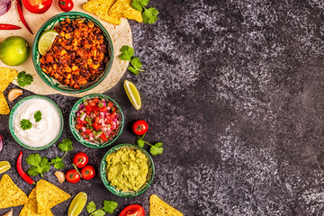 Mexican food concept: tortillas, nachos with guacamole, salsa.