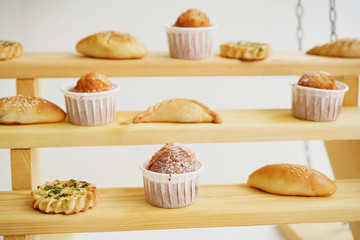 Baked pies and cakes on wooden shelves