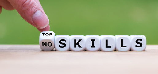 Hand turns a dice and changes the expression "no skills" to "top skills".
