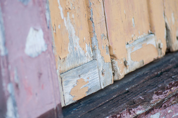 closeup of peeling paint on ancient wooden shutters