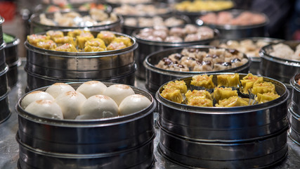 Vendor selling dumpling and shaomai in asian street food market of Taiwan