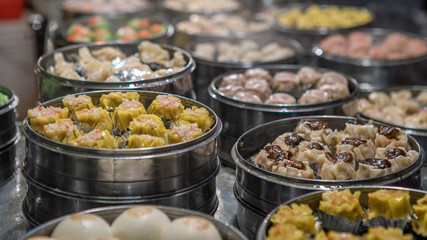 Vendor selling dumpling and shaomai in asian street food market of Taiwan