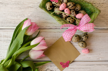 Easter egg and beautiful Tulips on a wooden background. Image