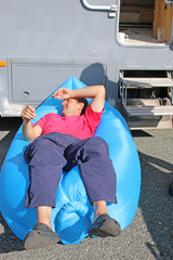 Man relaxing in an inflatable lounger