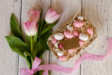 Easter egg and beautiful Tulips on a wooden background. Image