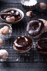 Homemade donuts with sugar and cinnamon on a wooden background. Rustic style.