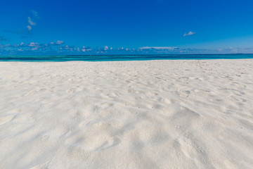 Fototapeta na wymiar Simplicity and minimalism beach concept. White sand and blue sky, empty idyllic exotic beach landscape 