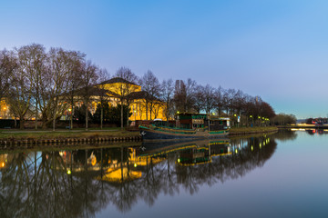 Germany, Old ship and buildings of saarbruecken city reflecting in saar river
