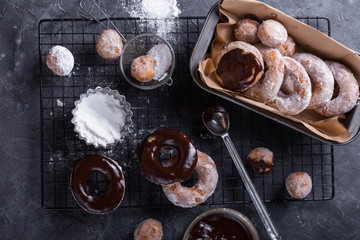 Homemade donuts with sugar and cinnamon on a wooden background. Rustic style.