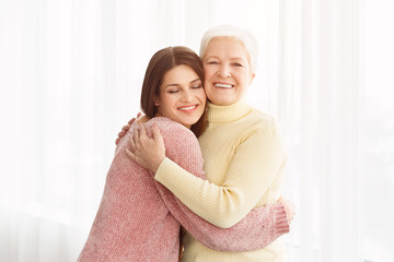 Young woman embracing her mother with love