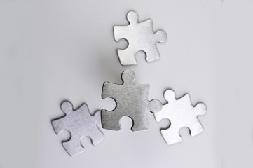 Obraz premium metal puzzle on a white background