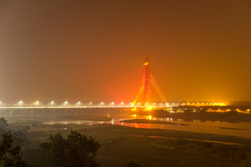 Obraz premium cable-stayed bridge illuminated across the Yamuna River at night. Signature Bridge. Delhi india