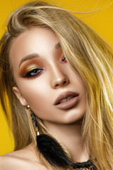 Fototapeta premium Blonde with great makeup. Yellow background. Portrait
