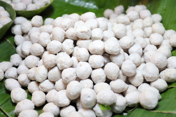 Pork balls on a banana leaf.