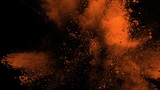 Super slowmotion shot of golden powder explosion isolated on black background.