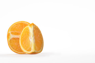 A half and a quarter of fresh juicy orange on a neutral white background